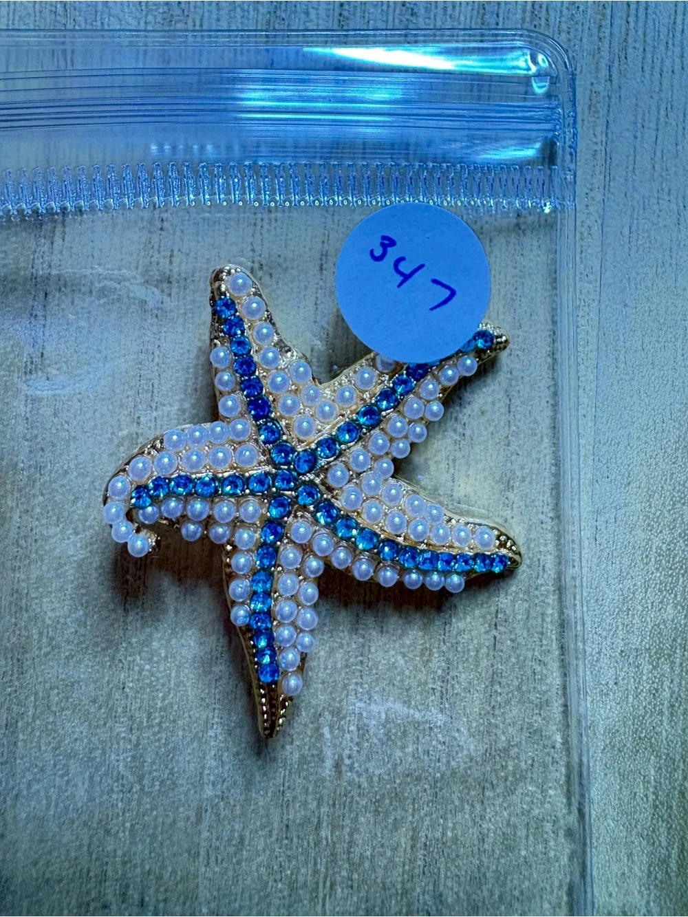 Gold Starfish Brooch with Blue Crystal Accents and Pearl Detail